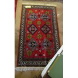 A red ground geometric pattern Persian rug.