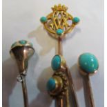 A yellow metal stick pin crown terminal with initials set turquoise (i.c.) and four other stick pins