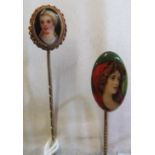 A Victorian stick pin with painted on porcelain miniature of a lady in gilt surround and another