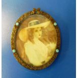 A miniature of a lady in oval frame set turquoise coloured stones