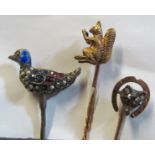 An enamel, seed pearl and gem stone stick pin of a duck, a yellow metal stick pin squirrel and a fox