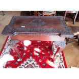 A 19th Century carved card table on cabriole legs