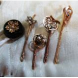 A Victorian mourning stick pin set seed pearls and four other stick pins set seed pearls
