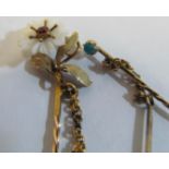 A Victorian stick pin with chain set flowerhead (i.c.)