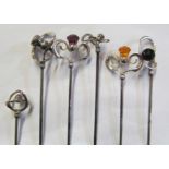 Six Charles Horner silver hat pins four with thistle shaped stones amongst scrolls and two similar