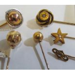 A yellow metal semi-circular ball design stick pin with pierced rim and five other Victorian stick