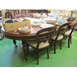 A Victorian mahogany extending dining table with two leaves