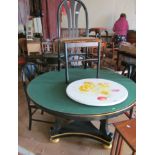 A circular topped black and gilt dining table with four modern black and leopard print chairs