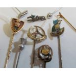 An enamel and white stone jockey stick pin (a/f) and eight other stick pins