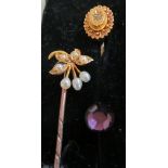 A Victorian 15ct gold stick pin set seed pearl flower head and two other Victorian stick pins (i.