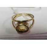 A 9ct gold ring set yellow stone