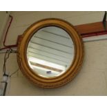 A gilt oval mirror