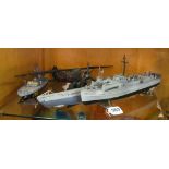 A model plane and three model kit naval vessels