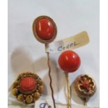 Four Victorian yellow metal and coral inset stick pins