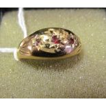A 9ct gold gypsy ring set three red stones