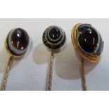 Three Victorian yellow metal stick pins set agate stones