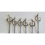 Six Charles Horner silver treble clef hat pins on steel stems displayed on card