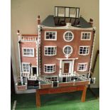 A large 1980's dolls house 'The Manor' with later basement and side annex complete with handmade and