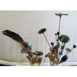 Various decorative hat pins in two hat pin holders