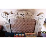 A carved white painted headboard
