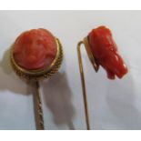 A 19th Century stick pin with carved coral horses head and another coral cameo lady