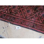 A red ground geometric Persian rug.
