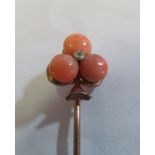 A Victorian coral trefoil shaped stick pin and another coal one (i.c.)