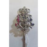 A white metal stick pin with pierced ER and crown terminal set diamonds, sapphires and rubies (i.