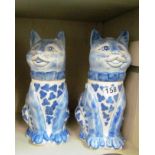 A pair of blue and white cats with loose heads.