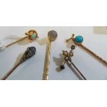 A 15ct gold and opal stick pin and four other stick pins