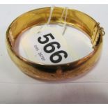 An 18ct gold engraved bangle bracelet