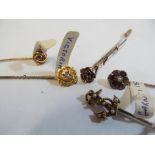 A Victorian seed pearl anchor stick pin and four other Victorian stick pins