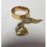 A gold ring with two charms