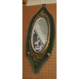 A brass mirror on velvet.