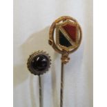 A Victorian yellow metal stick pin set bloodstone in shield shape and another set garnet (i.c.)