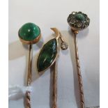 A Victorian yellow metal stick pin with green stone leaf and diamond terminal (a/f) and two other