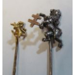 A Victorian yellow metal stick pin lion rampant and another white metal stick pin lion rampant