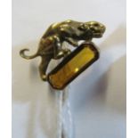 A yellow metal stick pin panther crouching on tourmaline
