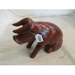 A 19th Century Chinese carved wood red lacquer pig with traces of gilding