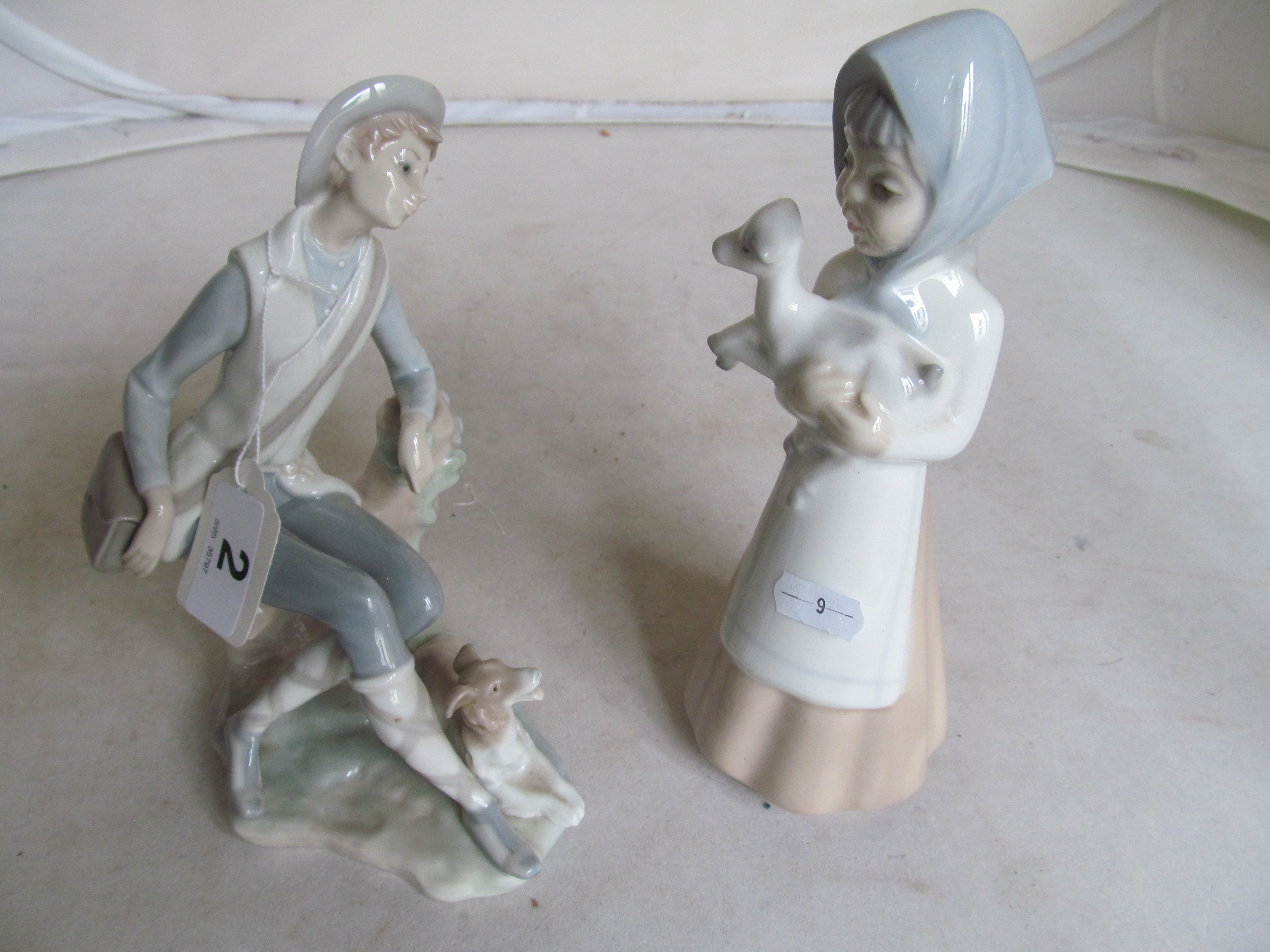 A Lladro figure man and dog and another Spanish figure