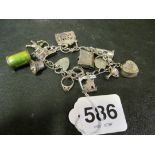 A silver charm bracelet hung and charms