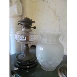 An oil lamp and an opaque glass shade