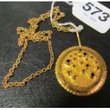 An 18ct gold chain with yellow metal sunburst pendant