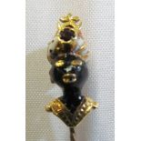 A yellow metal stick pin enamel Blackamore with coral and ruby to turban