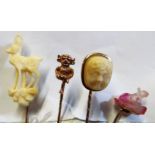 A carved crystal stick pin mouse, one with stag, another Leprechaun and another cameo