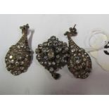 A pair of diamante drop earrings and a similar pendant/brooch