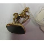 A 9ct gold fob horse with shield