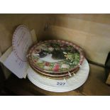 Three Charles Dickens plates and four cat plates.