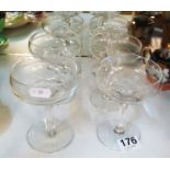 A set of six monogrammed champagne glasses with faceted stems