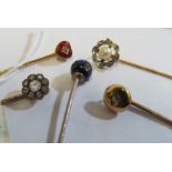 A stick pin set enamel and diamond heart and four other Victorian stick pins